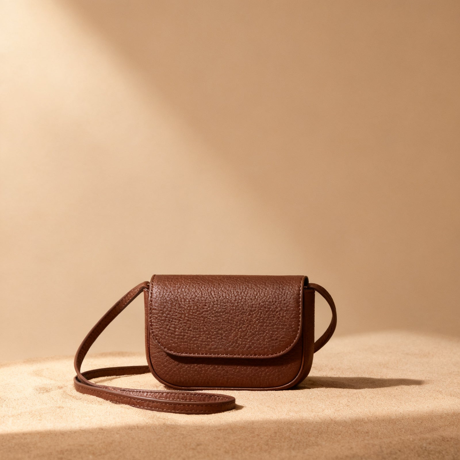 The Mini Crossbody in chocolate exterior, front view