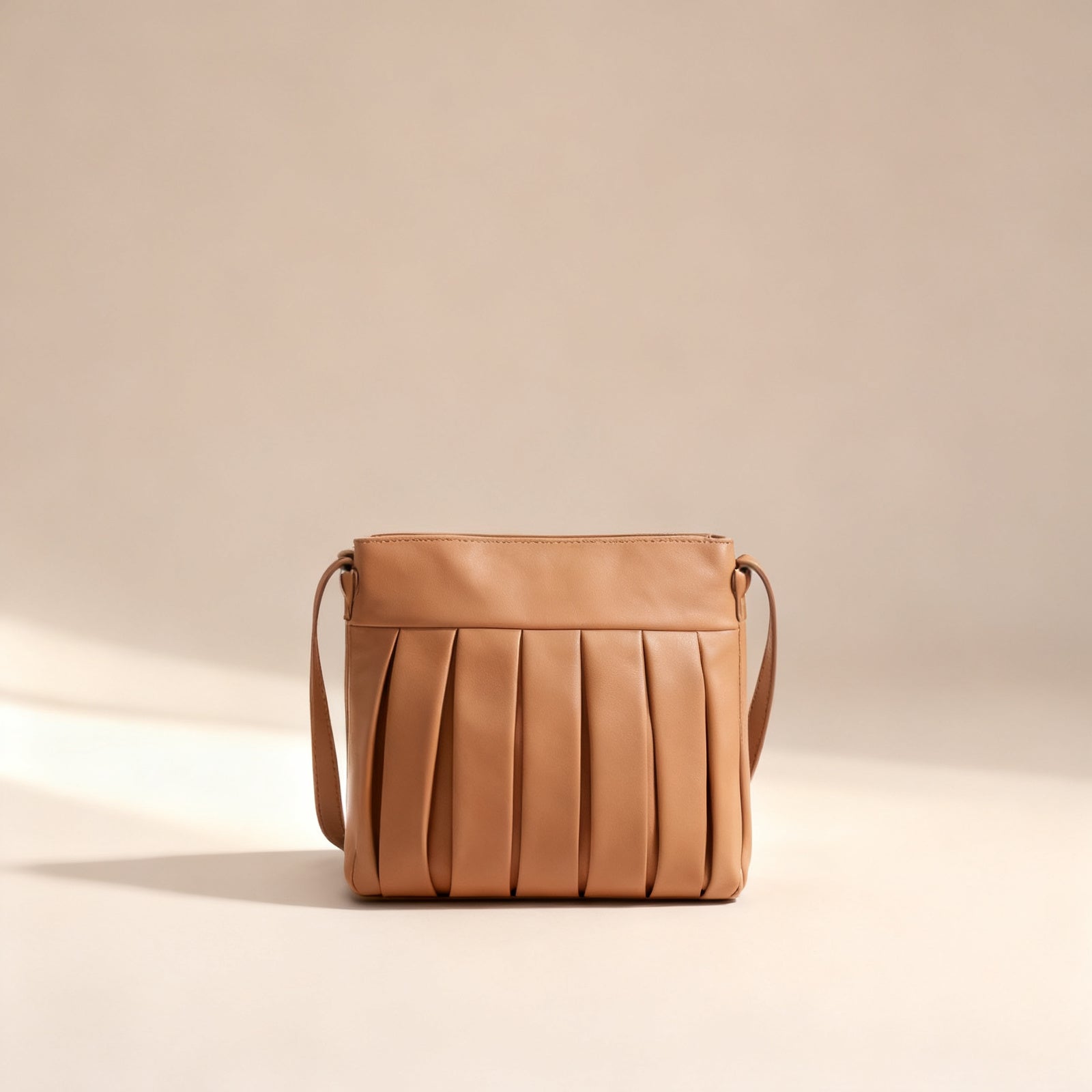 The Pleated Shoulder Bag in tan exterior, front view