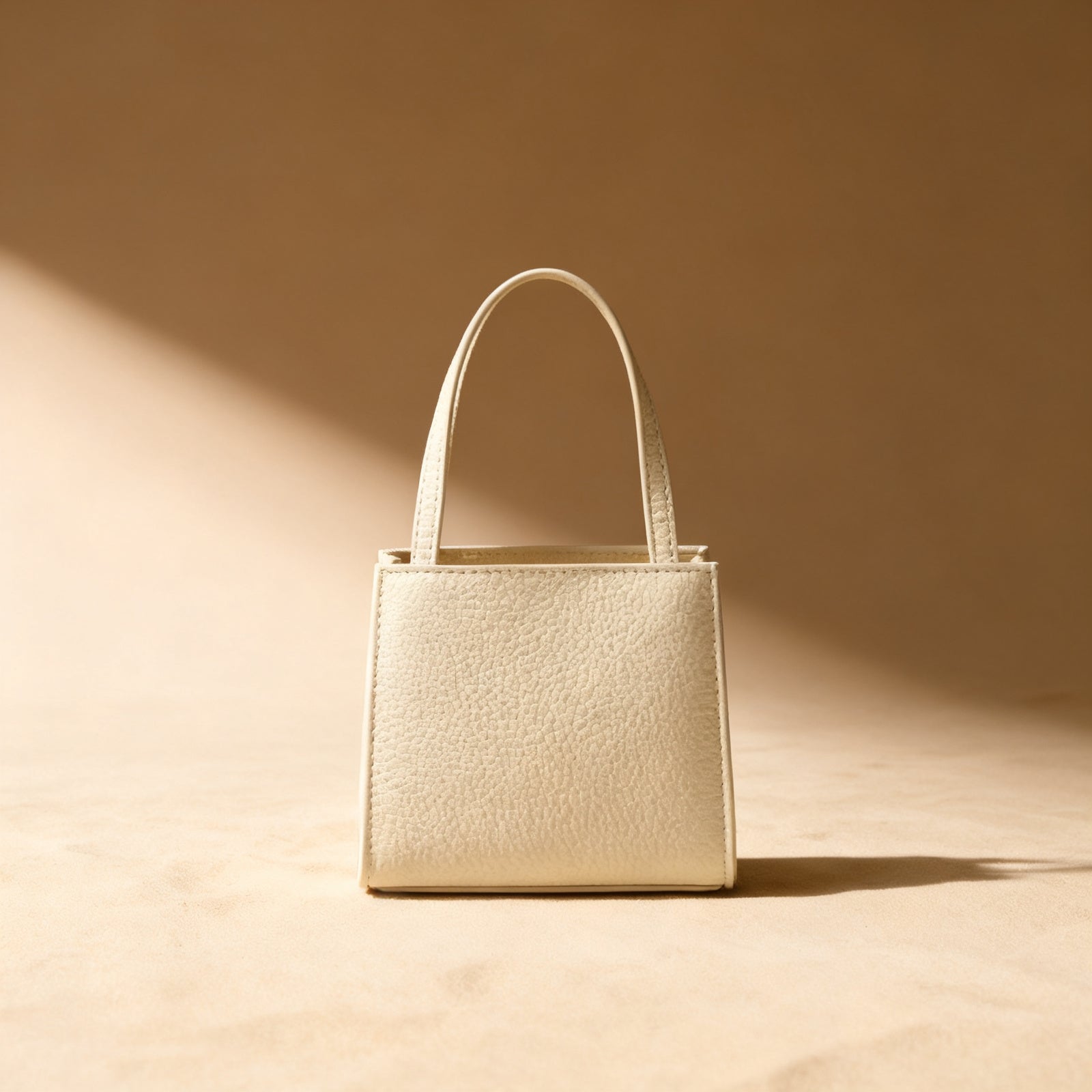 The Mini Tote in cream exterior, front view